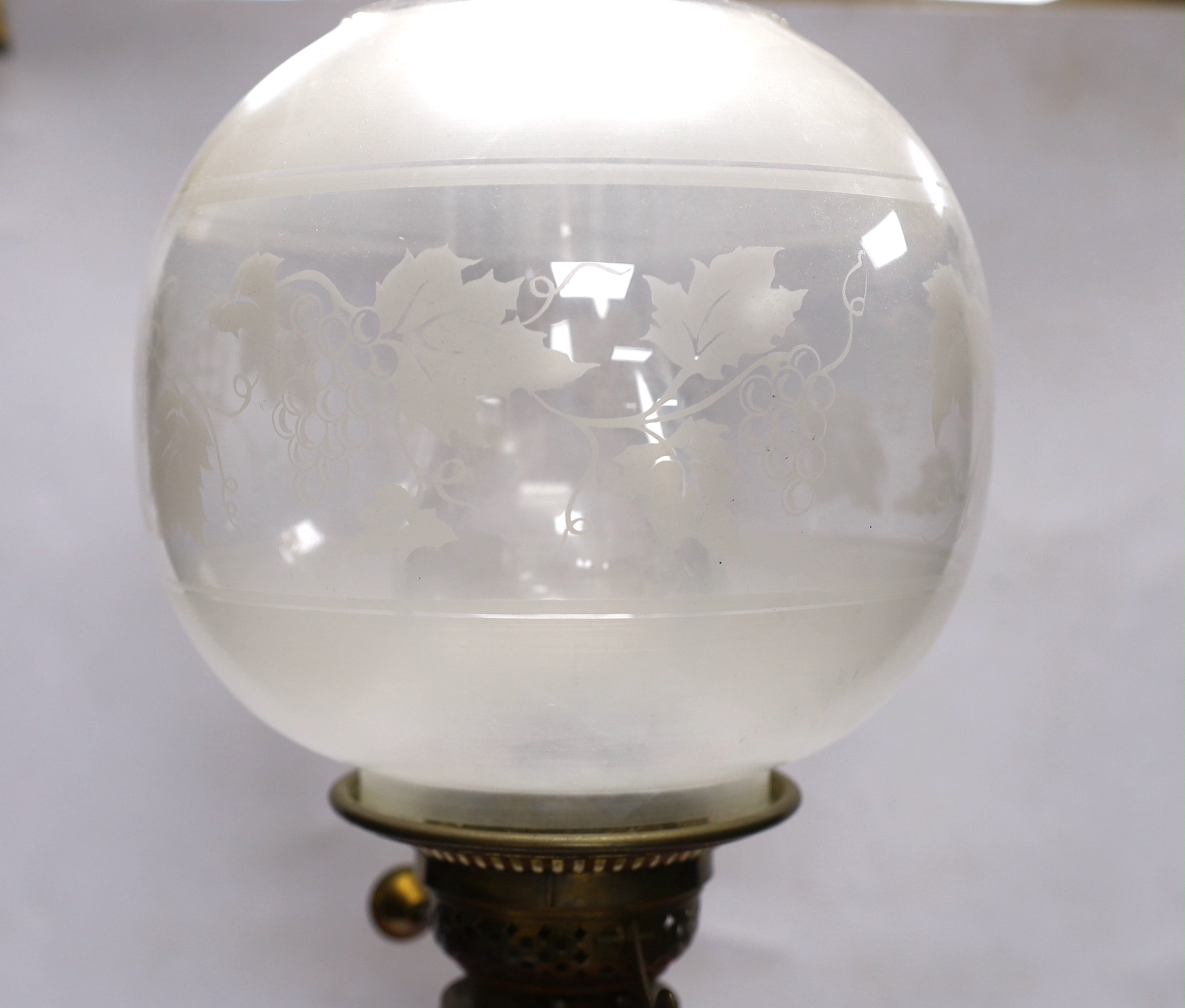 A late 19th century pink and white glass oil lamp, 73cm high